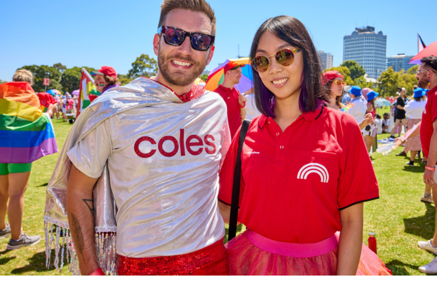 Two Coles team members in black celebrating pride outdoors