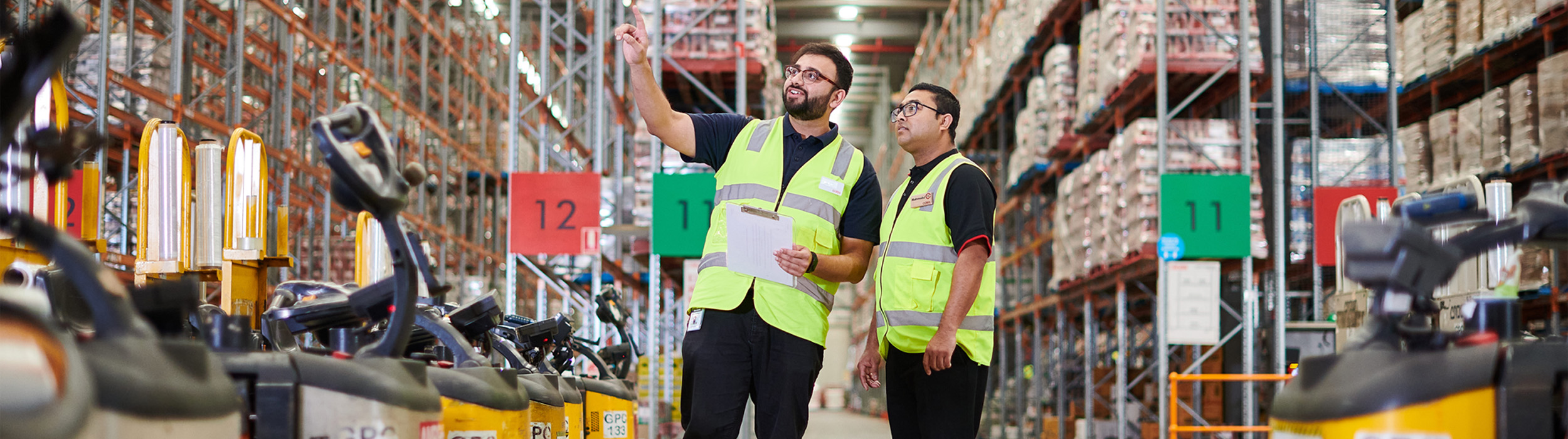 Two employees working at the Coles distribution Centre