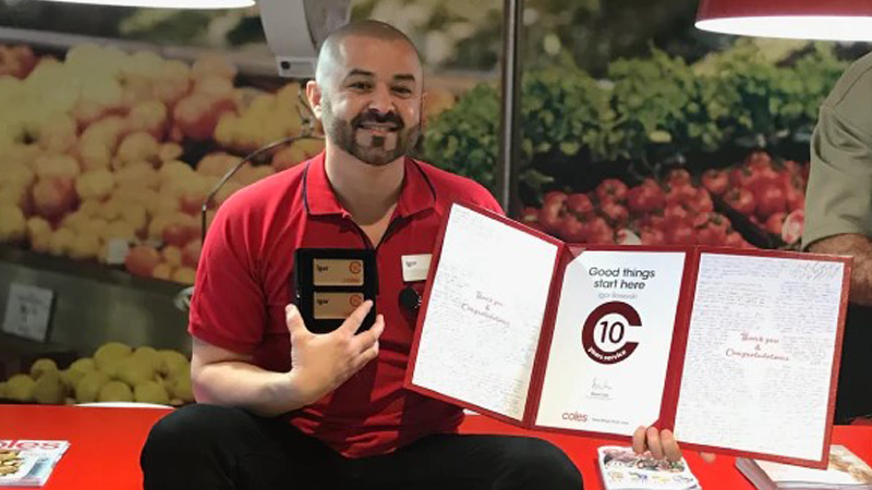 Coles team member with a long service award