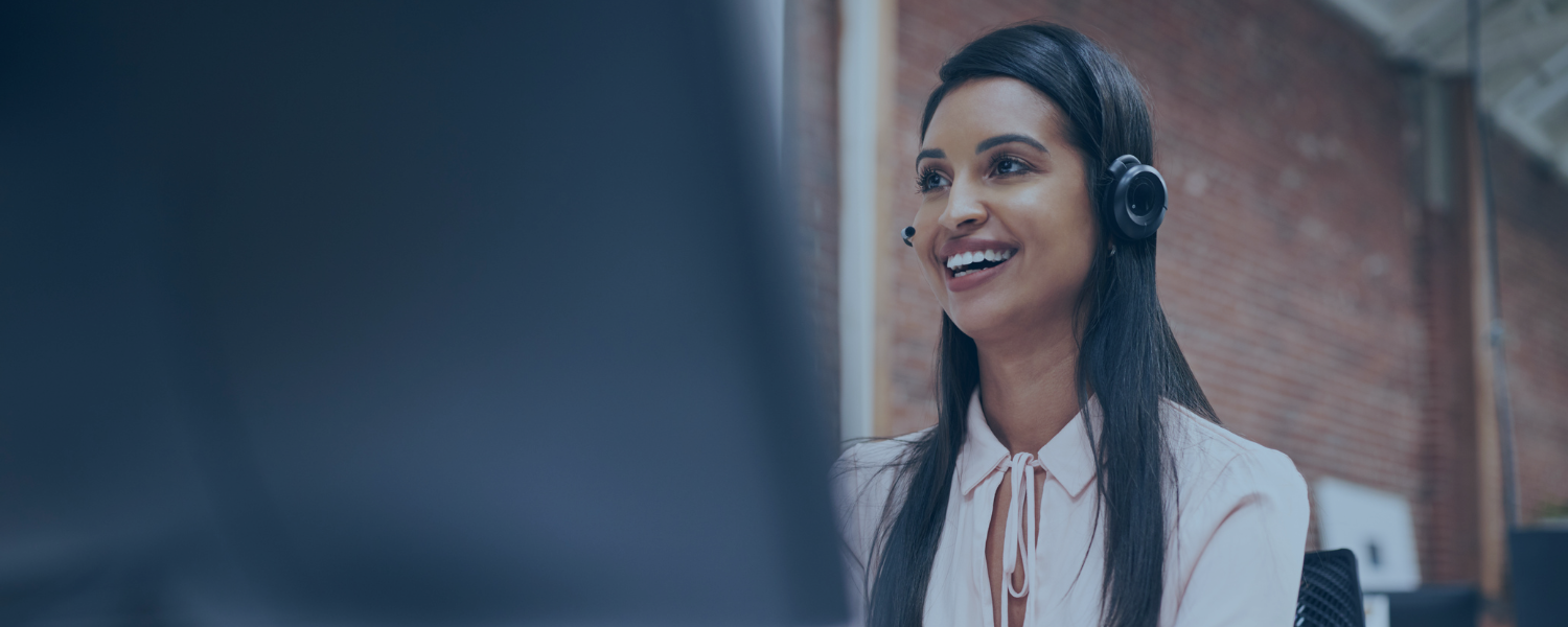 Customer Service employee smiling and talking on headset