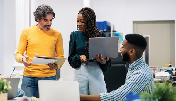 A diverse team of coworkers analyzes work performance and results.