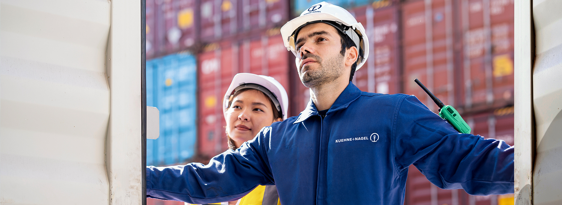 Workers in front of containers