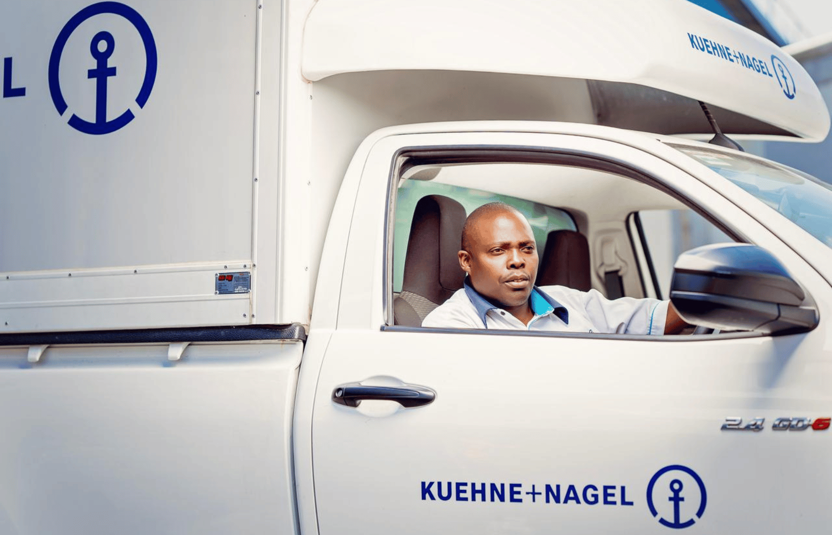 Kuehne+Nagel Driver in a van