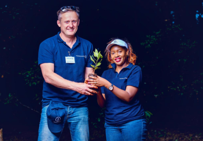 Kuehne+Nagel employees holding plant