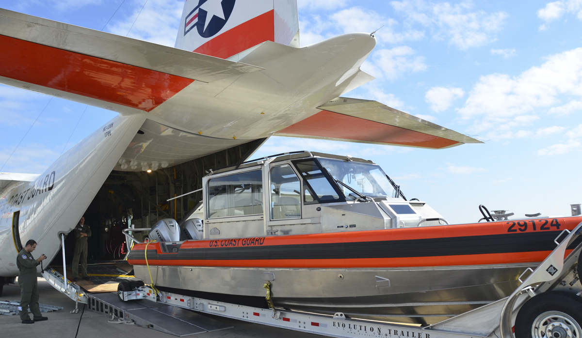 Metal Shark boat being loaded into a Coast Guard Plane