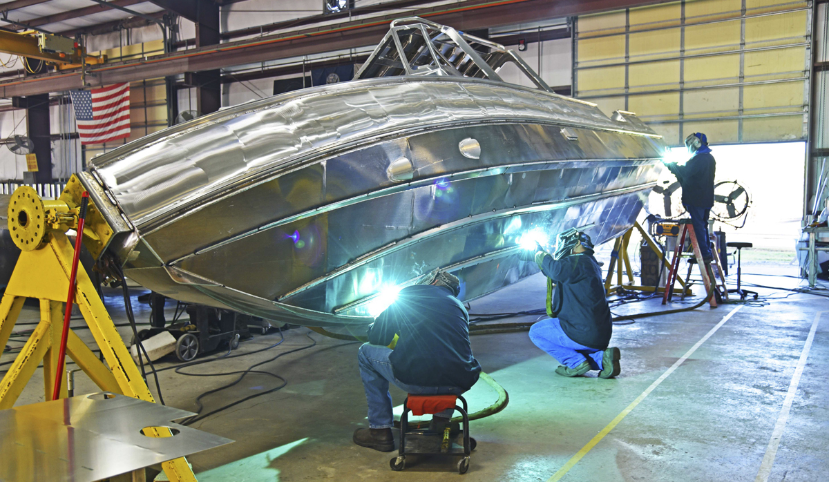 Welders welding a Metal Shark Boat hull 
