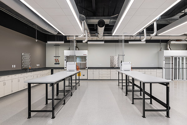 Clean, modern laboratory with worktables, ventilation systems, and white cabinetry at Skyfall Biologicals.