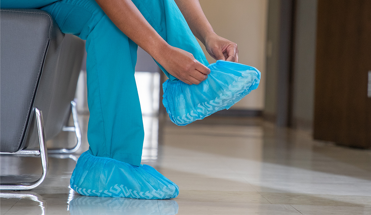 Health Care Worker putting on PPE
