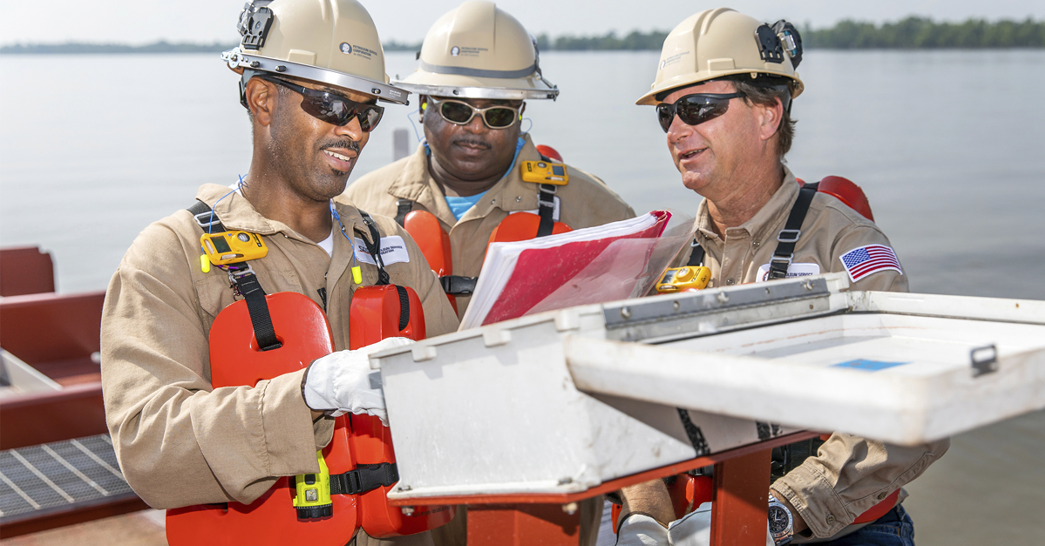 A picture of 3 PSC employees inspecting equipment