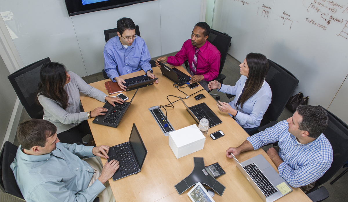 Picture of a team meeting around a table
