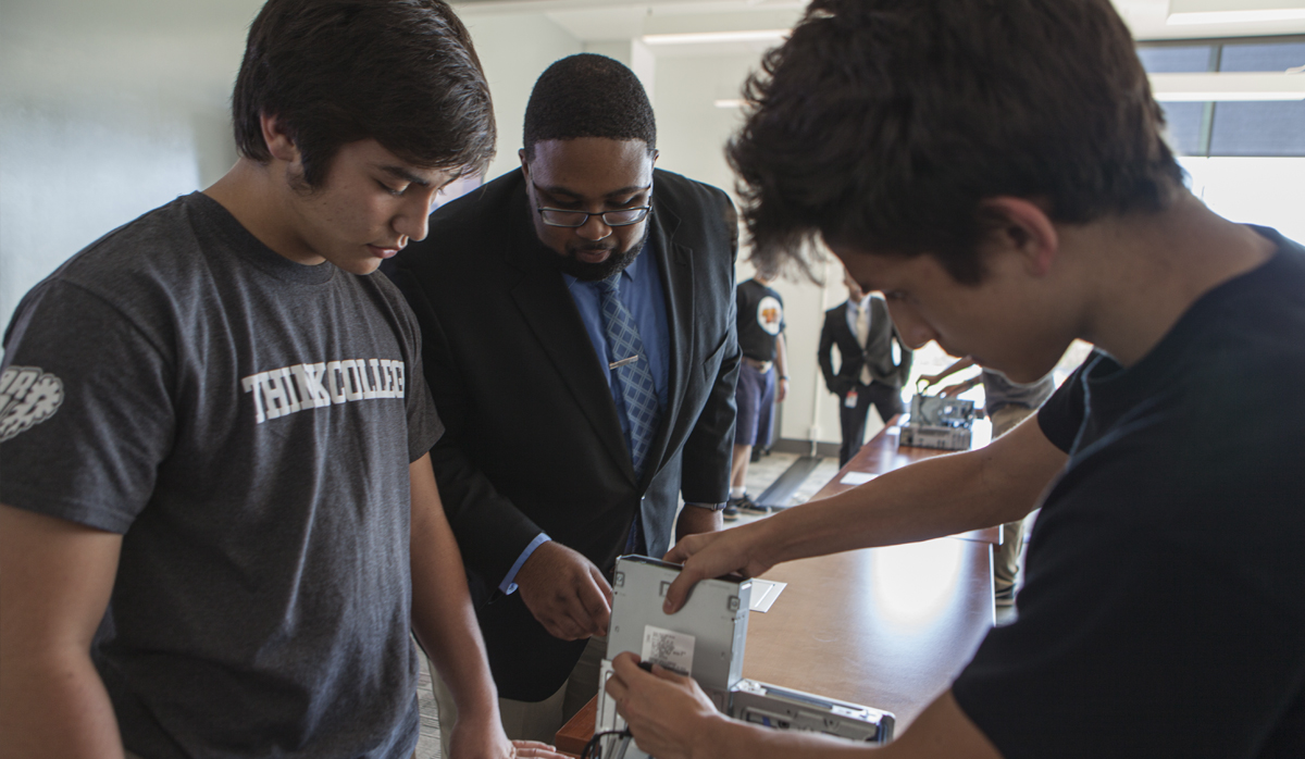 picture of three individuals constructing a computer
