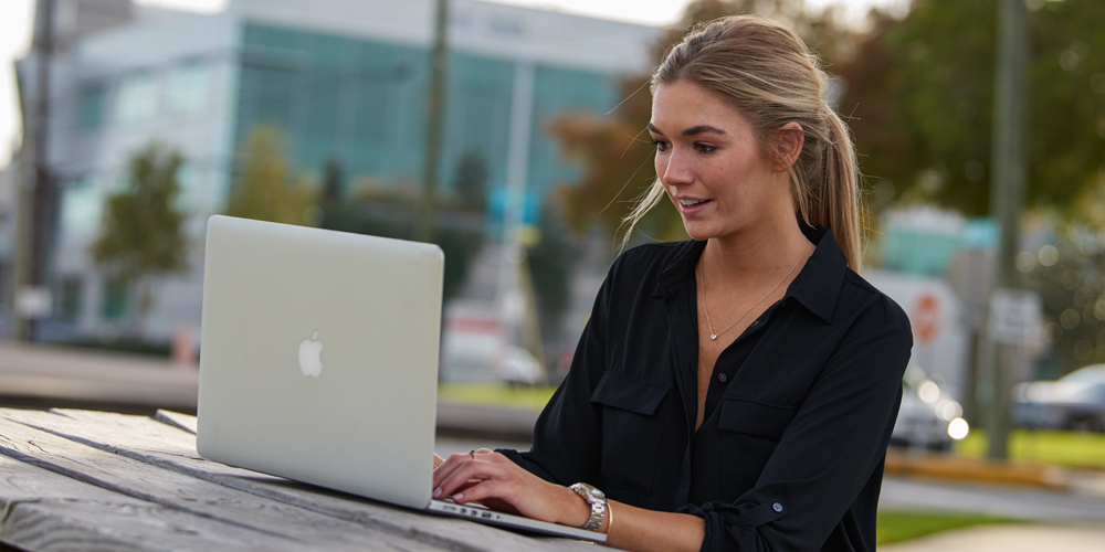 individual reading on a laptop