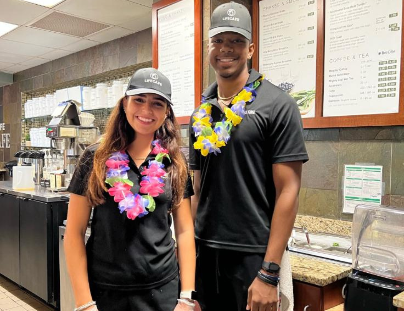Life Cafe team members back in the kitchen with lei's on for a tropical celebration.