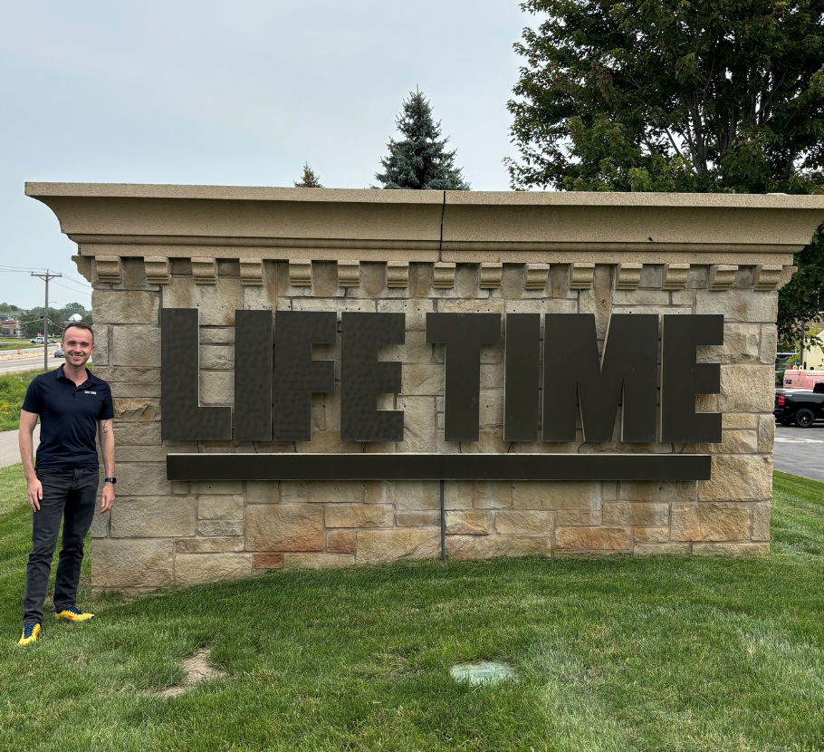 Male, Public Relations Manager standing outside Life Time Corporate Office.