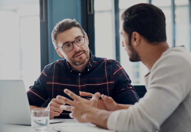 Two male Life Time finance employees working at the Life Time corporate office.