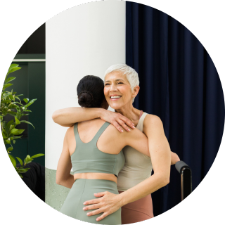 Life Time employee playing pickleball with his family at the Life Time outdoor courts.