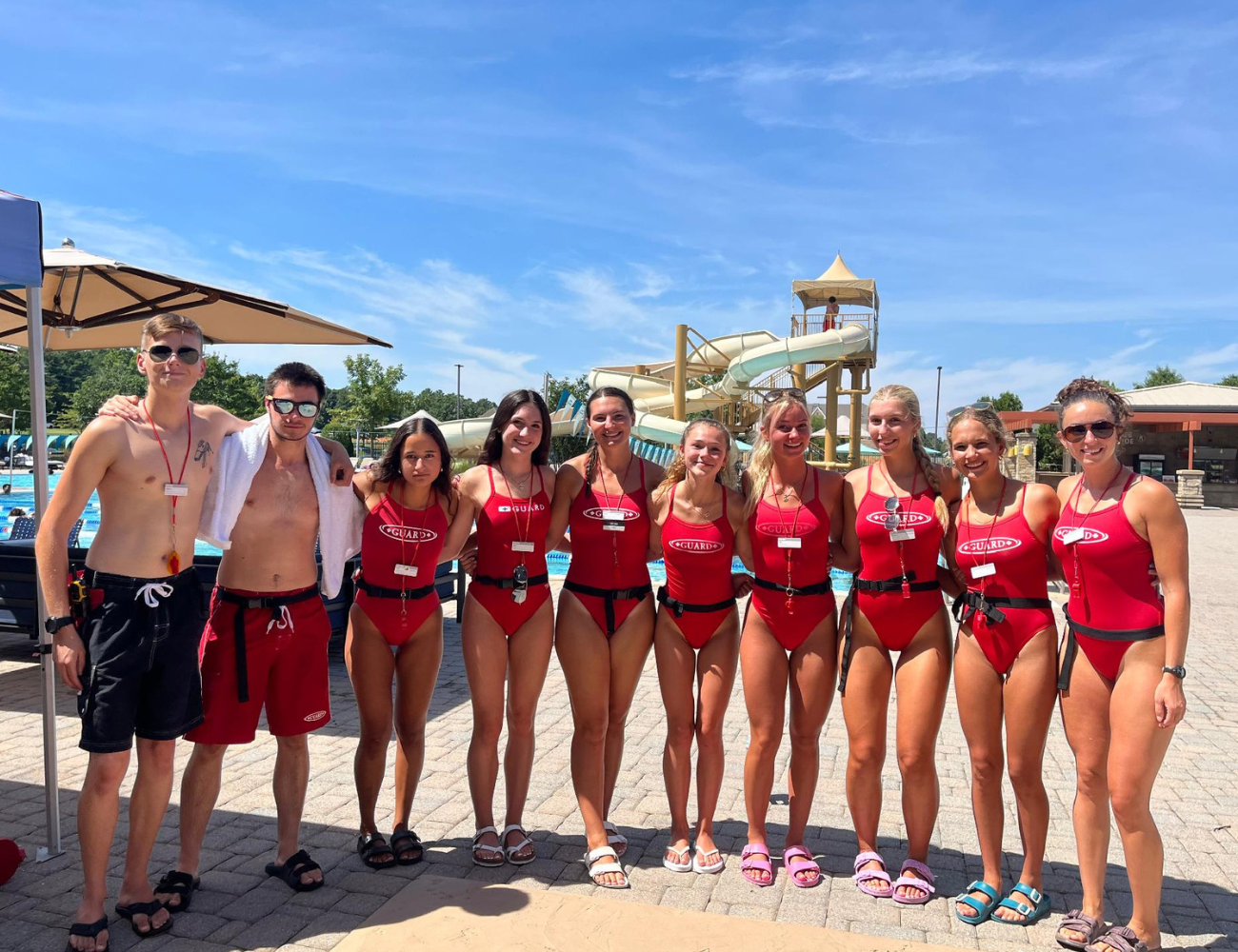 Life Time lifeguards outside at the pool.
