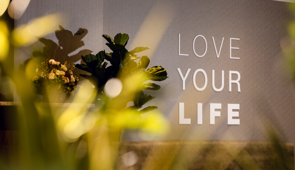 Life Time "Love Your Life" sign on the wall of a Life Time club.