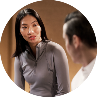 Life Time dynamic personal trainer assisting his client with an exercise. 