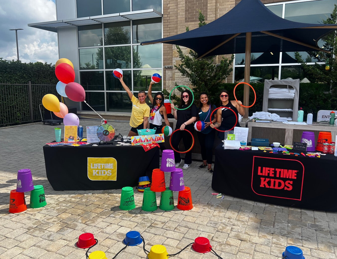 Life Time kids tables set up with balloons and decor to celebrate summer.