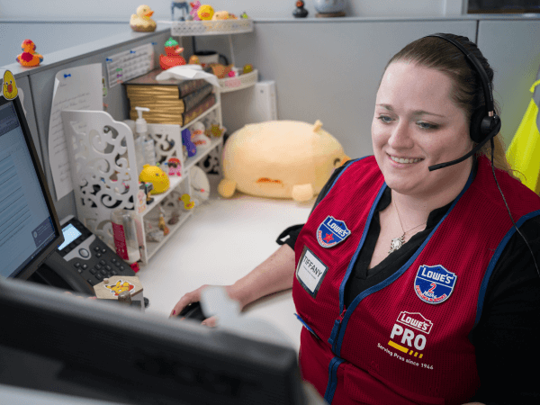 Lowe's contact center associate working at her desk