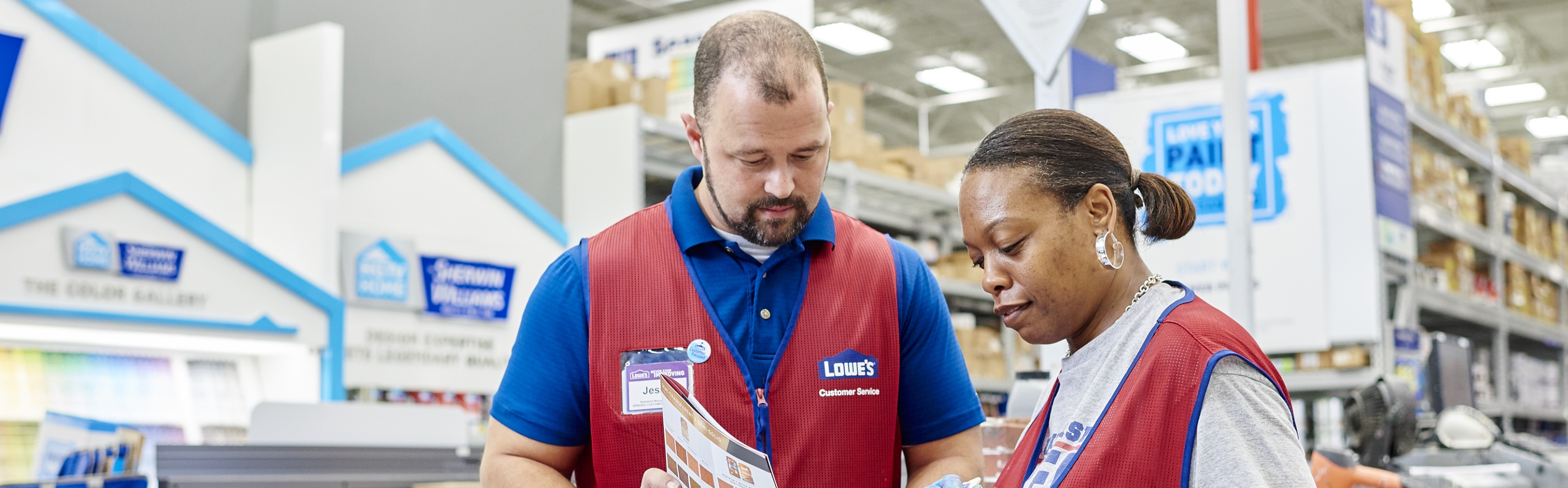 Lowe's associates working in the paint department 