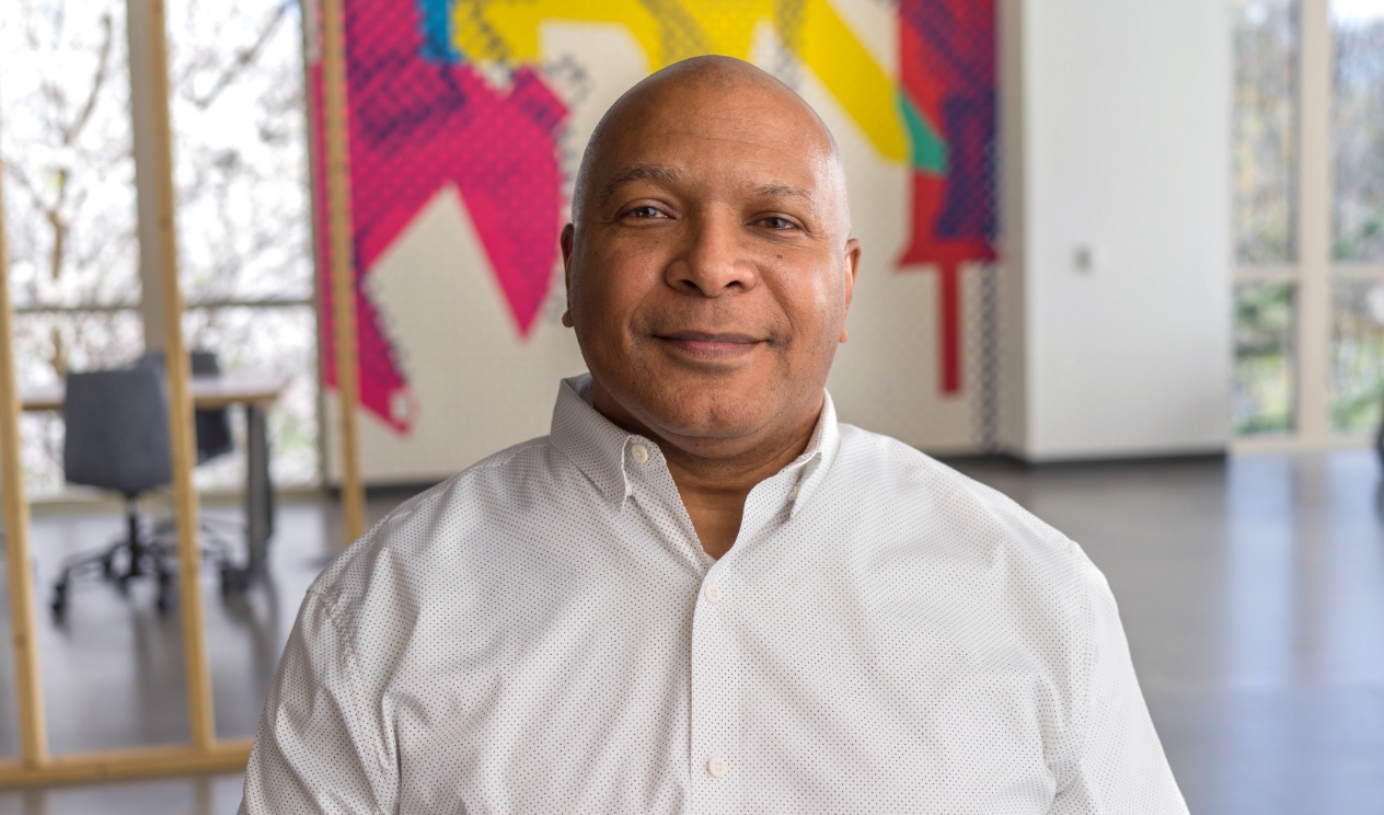 Male associate sitting in an open workspace at Corporate Headquarters