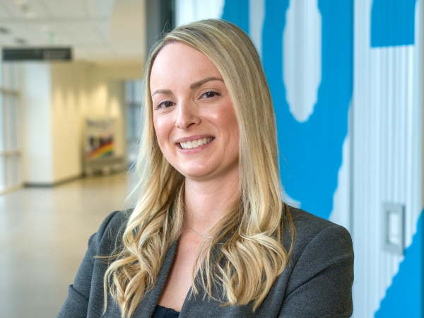 Female associate standing in a hallway of Corporate Headquarters