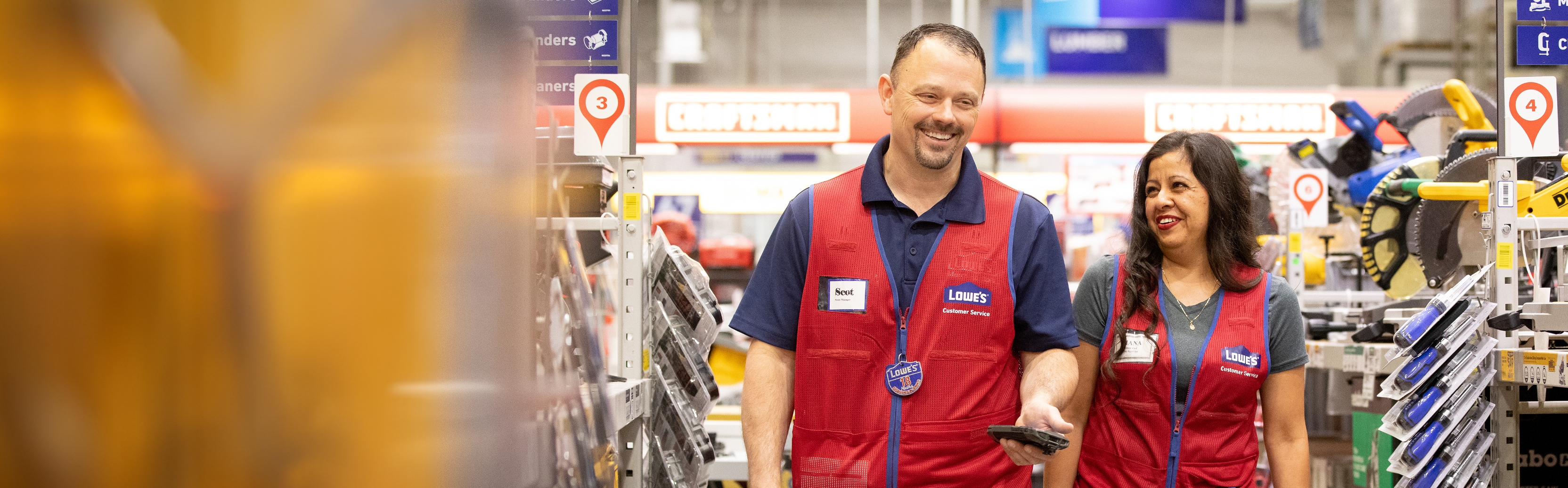 Store Manager walking through the store with an associate