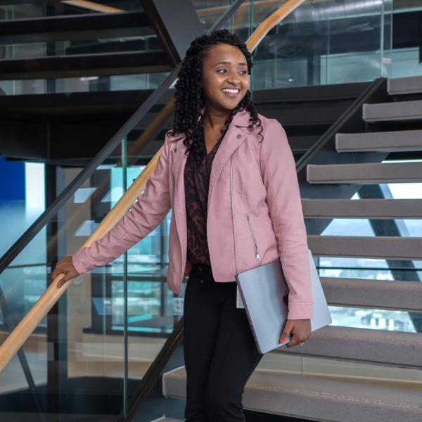 Female associate walking down the steps of the Tech Hub