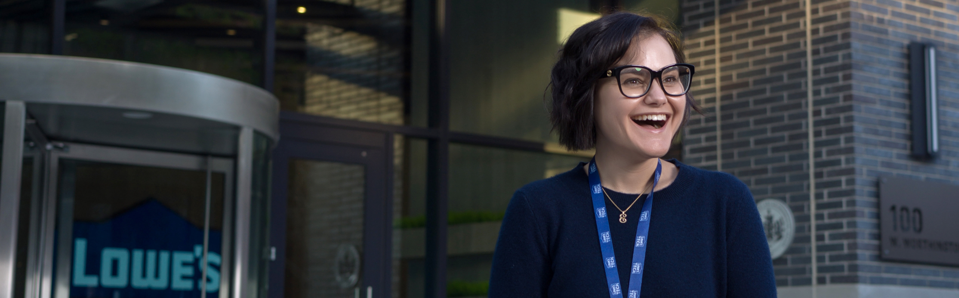 Female associate standing outside of the Tech Hub