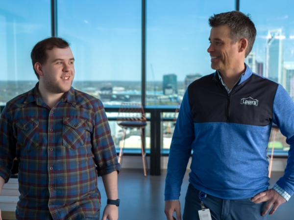 Two male associates walking through the Tech Hub