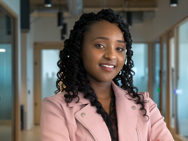 Female associate in an open workspace at the Tech Hub