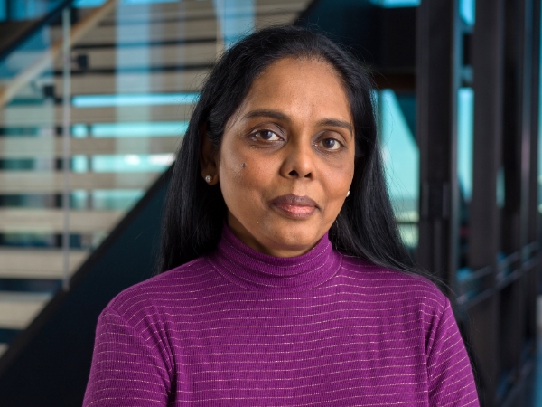 Female associate standing by the steps at the Tech Hub