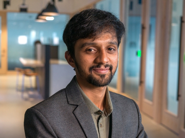 Male associate sitting in an open workspace at Corporate Headquarters