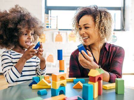Mother and child playing with building blocks