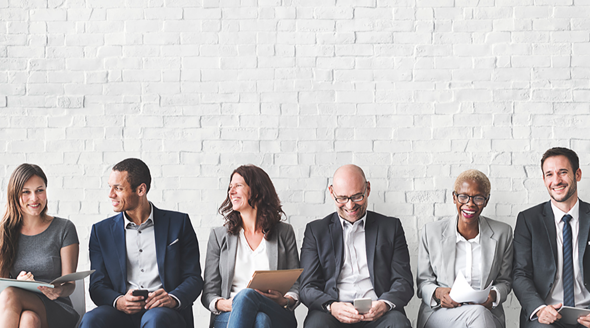 Six people sitting down next to each other