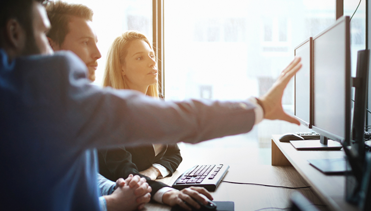 employees looking at a computer together