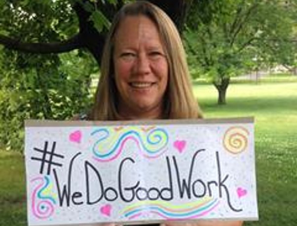Jane, a Magellan employee, holding a sign saying "We do good work"