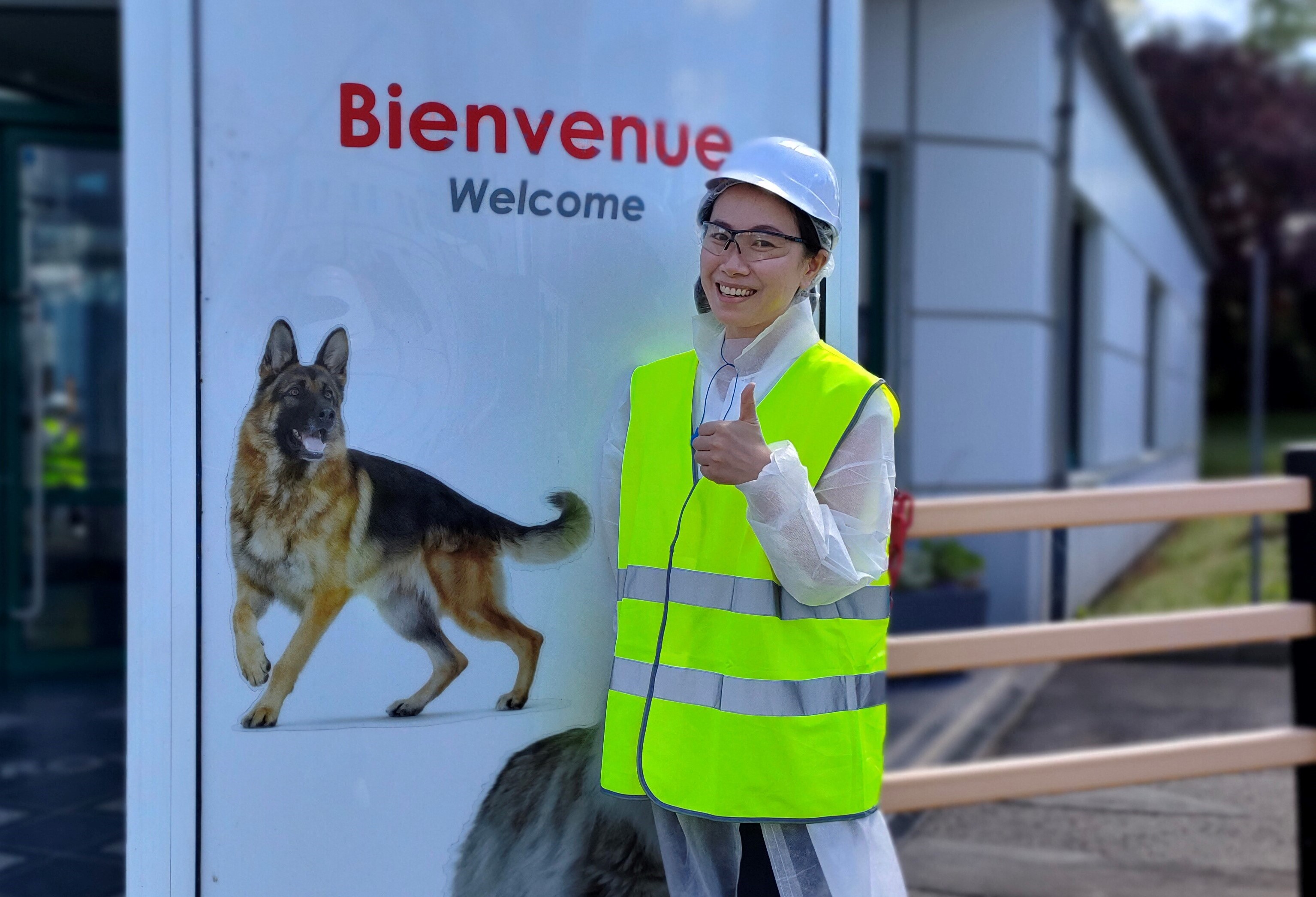 A image of a Mars Associate in PPE smiling with their thumbs up