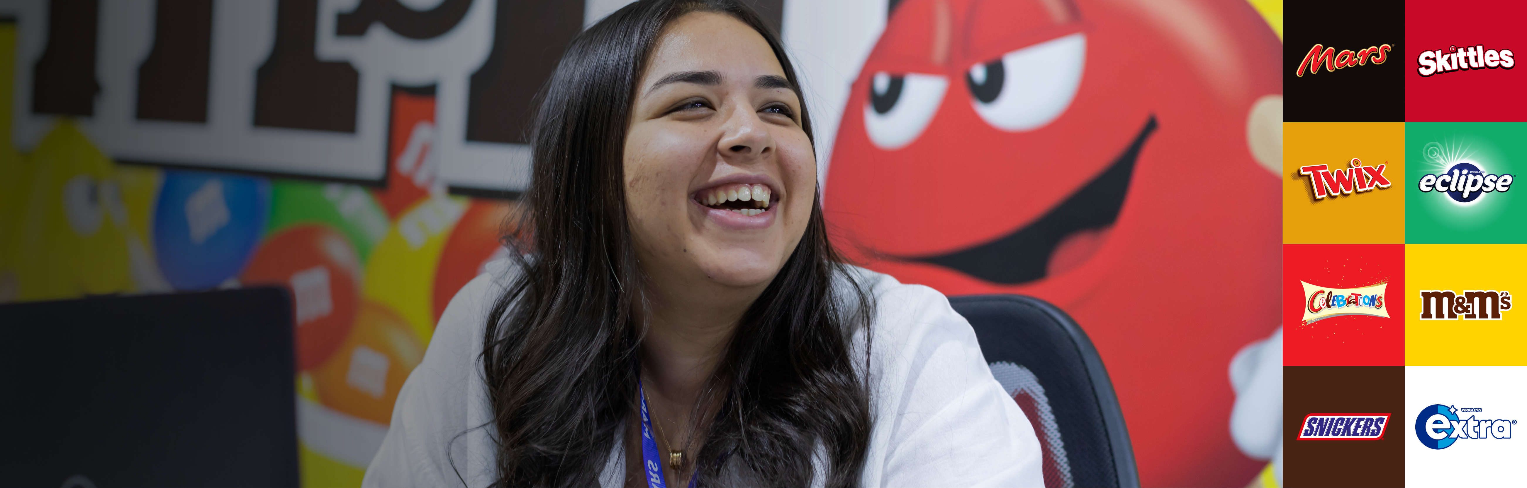 A image of a Mars Associate laughing with a M&M's background