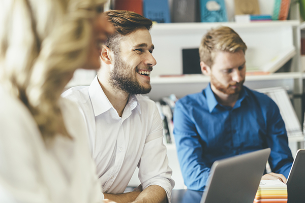 Man smiling in conference meeting room