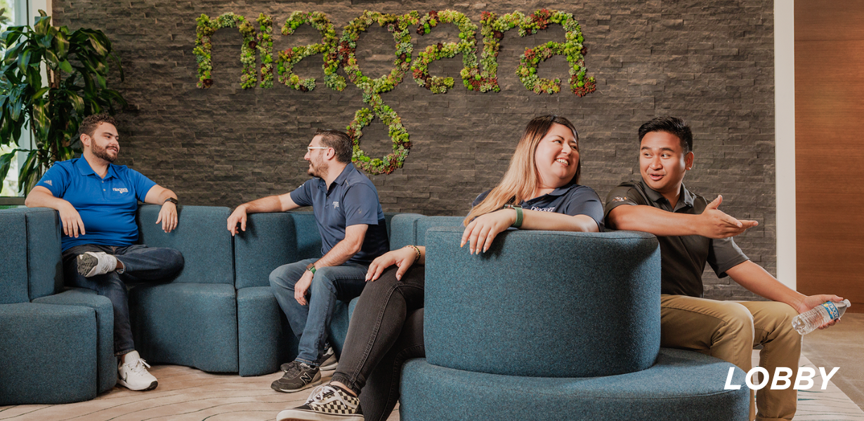 Image of Niagara lobby; blue couch in a "squiggly" shape in front of a cement wall with "niagara" written in plants 