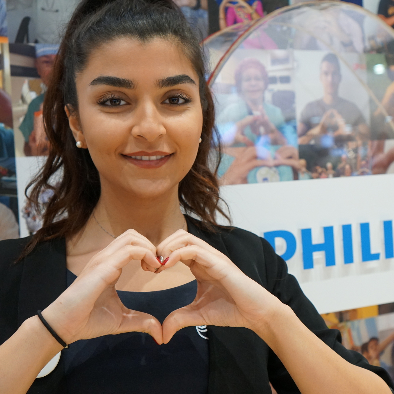 Young intern making a heart sign at Philips Campus