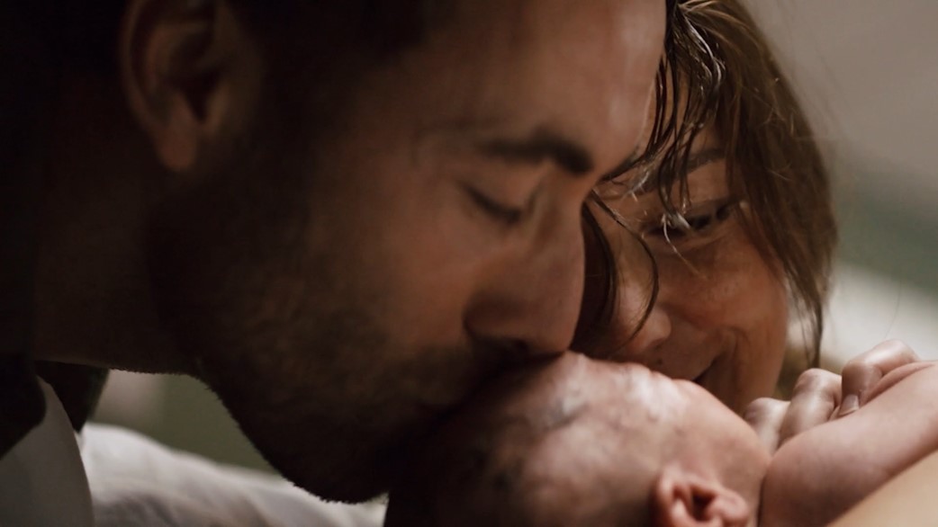 Parents kiss their new born child - Philips regulatory jobs