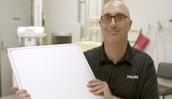Philips employee holding machineary. 