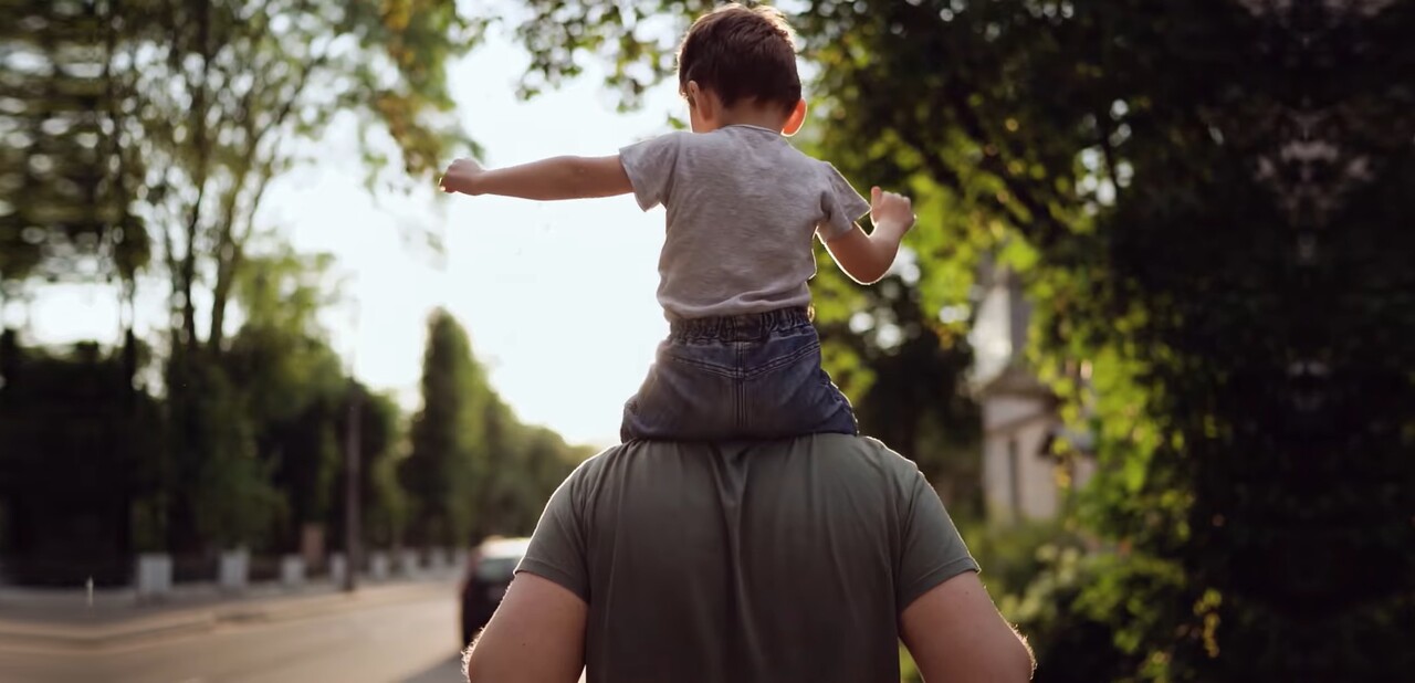A father carrying his son on his shoulders - Philips