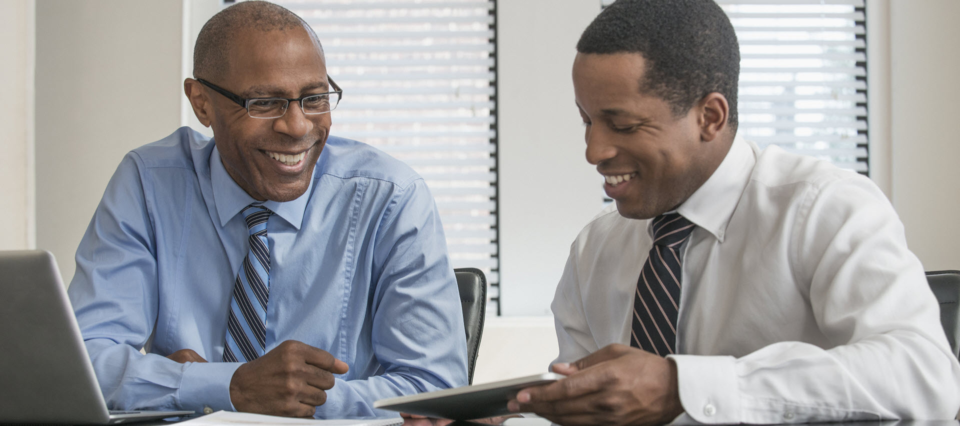 Two men meeting in an office reviewing data