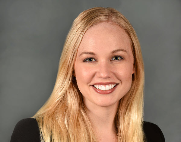 Michelle B. smiling at the camera. She has long straight, blond hair that ends just past her shoulders.