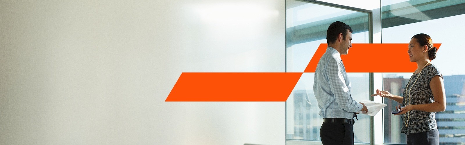 two colleague having a discussion outside the office door